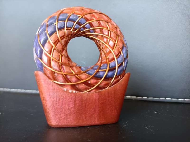 torus rodin coil pendant Sunrise Orange with flashes of pink and purple swirls gallery