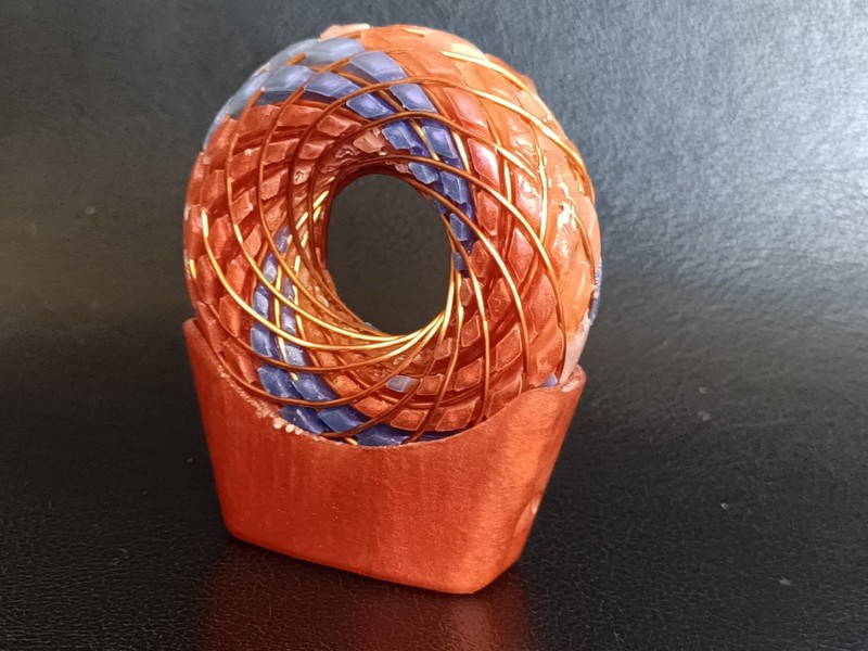 torus rodin coil pendant Sunrise Orange with flashes of pink and purple swirls gallery