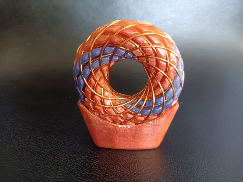 torus rodin coil pendant Sunrise Orange with flashes of pink and purple swirls gallery
